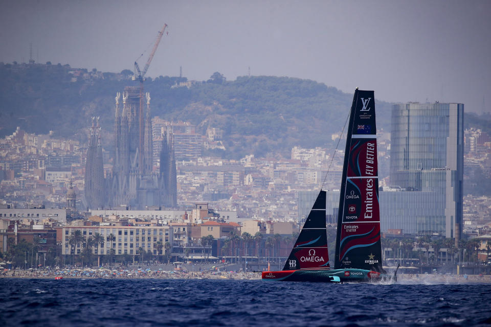 Backdrooped by the Sagrada Familia church, Emirates Team New Zealand's AC75 boat sails during America's Cup Preliminary Regatta ahead of the 37th America's Cup sailing race at the Barcelona's coast, Spain, Thursday, Aug. 22, 2024. The world's oldest international sports trophy, best yachtsmen and cutting-edge design and technology will come together in Barcelona when the 37th edition of the America's Cup starts on Thursday. (AP Photo/Joan Monfort)