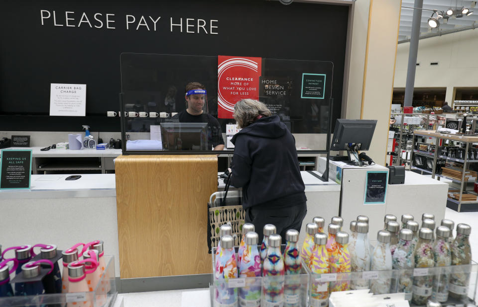 A customer purchases an item in the homeware section at John Lewis in Kingston as non-essential shops in England open their doors to customers for the first time since coronavirus lockdown restrictions were imposed in March. (Photo by Steve Parsons/PA Images via Getty Images)