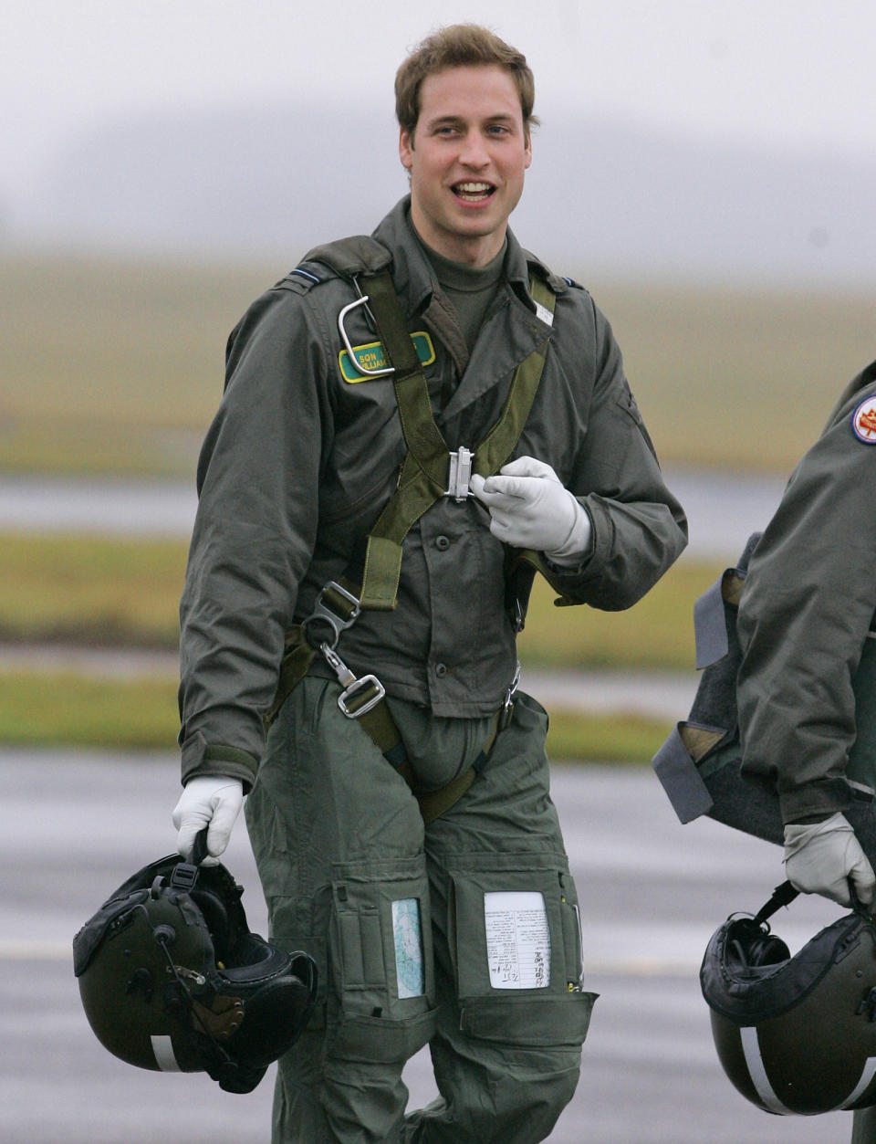 FILE Britain's Prince William gestures as he walks across the airfield at RAF Cranwell, Lincolnshire, England, Thursday, Jan. 17, 2008. The world watched as Prince William grew from a towheaded schoolboy to a dashing air-sea rescue pilot to a father of three. But as he turns 40 on Tuesday, June 21, 2022, William is making the biggest change yet: assuming an increasingly central role in the royal family as he prepares for his eventual accession to the throne. (AP Photo/Kirsty Wigglesworth, File)