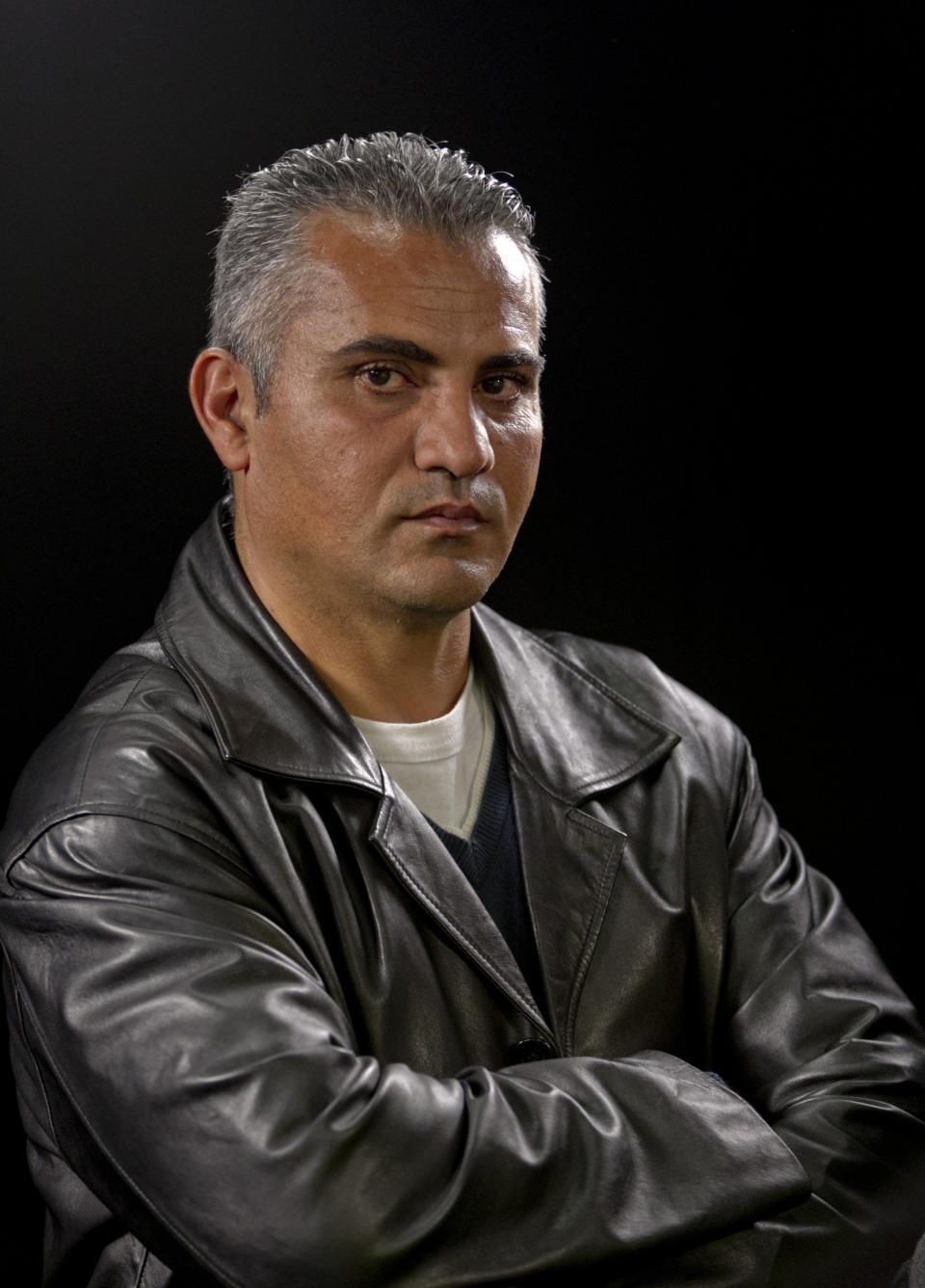 FILE - In this Tuesday, Feb. 5, 2013 photo, documentary film director Palestinian Emad Burnat poses for a photo after an interview in Los Angeles. Immigration officials briefly detained the Palestinian director of the Oscar-nominated documentary "5 Broken Cameras" on his way into town for Sunday's Academy Awards. Burnat says that when he arrived at Los Angeles International Airport from Turkey with his wife and 8-year-old son late Tuesday, Feb. 19, 2013, he was told he didn't have the proper proof that he was a nominee. (AP Photo/Damian Dovarganes)