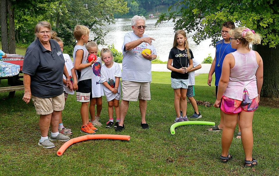 Donna Messerly (center) sets up a water balloon game at Charles Mill Lake during camp messy. Messerly has been an educator for 50 years and has a doctorate in adapted physical education. The 81-year-old is full of creative ideas for keeping kids active while having fun.