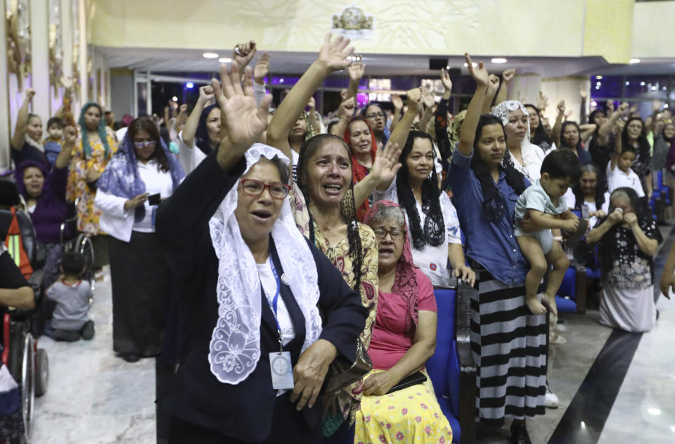 ADDS FIRST NAME - Women pray inside the "La Luz Del Mundo" or Light of the World church after they learned their church's leader Naasón Joaquín García was arrested in the U.S., in Guadalajara, Mexico, Tuesday, June 4, 2019. California authorities have charged Garcia, the self-proclaimed apostle of the Mexico-based church that claims over 1 million followers, with child rape, human trafficking and producing child pornography in Southern California. (AP Photo/Refugio Ruiz)