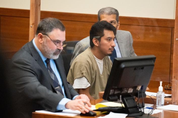 Gerson Fuentes, 27, who is charged with two counts of rape of a child under the age of 13, sits next to his then-defense attorney, Bryan Bowen, left, and a translator, Wolfgang Salazar, right, during his July 28, 2022 bond hearing. He was ordered held without bond pending trial. If convicted, he faces a maximum sentence of life in prison without any possibility for parole.