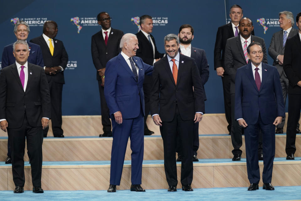 President Joe Biden puts is arm around Paraguay President Mario Abdo Benitez during a group photo at the Summit of the Americas, Friday, June 10, 2022, in Los Angeles. (AP Photo/Evan Vucci)