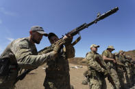 Servicemen of the newly created National Guard unit train in the Kharkiv region, Ukraine, Thursday, June 1, 2023. (AP Photo/Andrii Marienko)