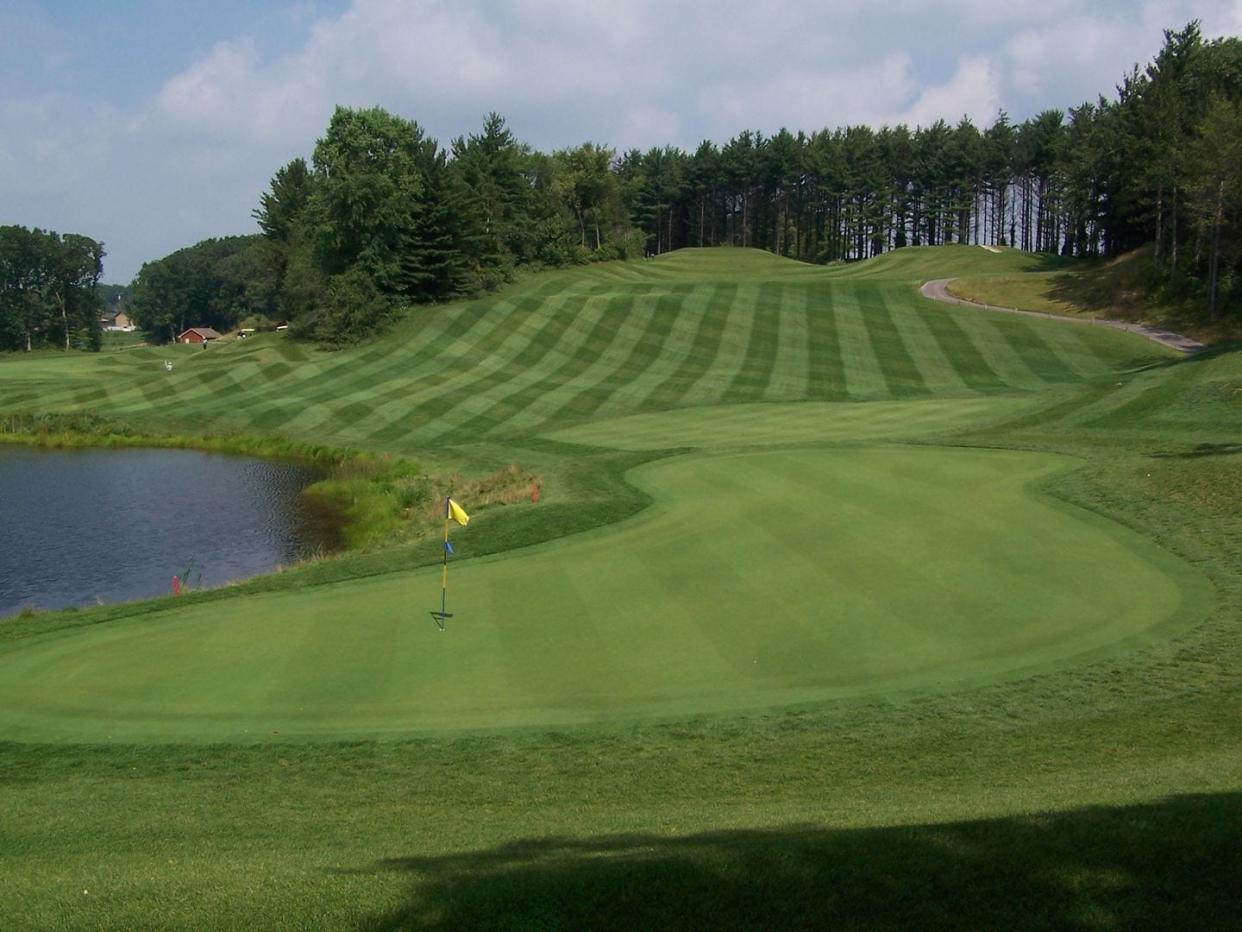 The signature par-3 16th hole at Moose Ridge Golf Course in South Lyon. It's an elevated tee shot that plays to a kidney-shaped green with water on your right. Bail left and you'll have a downhill lie in the rough with a green running away from you.