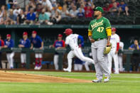 Oakland Athletics starting pitcher Frankie Montas (47) watches as Texas Rangers' Andy Ibáñez's (77) home run flies during the first inning of a baseball game, Monday, June 21, 2021, in Arlington, Texas. (AP Photo/Sam Hodde)