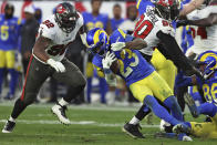 Los Angeles Rams running back Cam Akers (23) goes down in front of Tampa Bay Buccaneers defensive end William Gholston (92) during the second half of an NFL divisional round playoff football game Sunday, Jan. 23, 2022, in Tampa, Fla. (AP Photo/Mark LoMoglio)