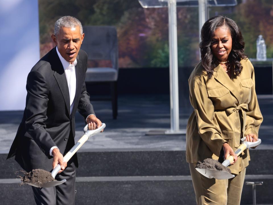 Barack and Michelle Obama shovel dirt at the groundbreaking of the Obama Presidential Center.