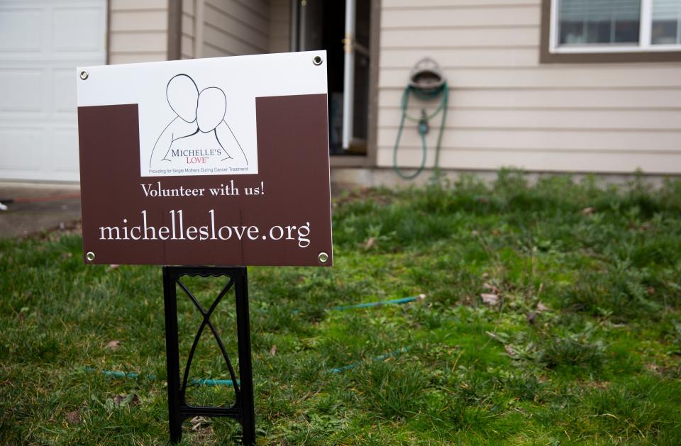 Lisa Painter's home is cleaned by local nonprofit Michelle's Love on Saturday, Jan. 22, 2022 in Salem, Ore. Painter, a single mom, was diagnosed with breast cancer in August 2021 and has received assistance through the nonprofit.