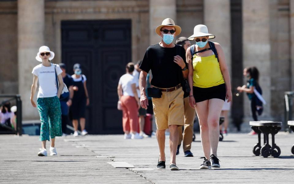 Masks are now compulsory in crowded outdoor areas in cities and towns across France - Gonzalo Fuentes/Reuters