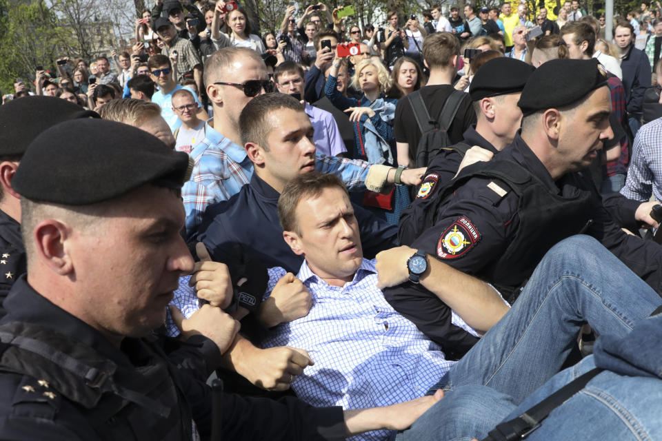 FILE - In this Saturday, May 5, 2018 file photo, Russian police carry opposition leader Alexei Navalny, center, from a demonstration against President Vladimir Putin in Pushkin Square in Moscow, Russia. German Chancellor Angela Merkel says Russian opposition leader Alexei Navalny was the victim of an "attempted murder by poisoning" and the aim was to silence him. Navalny was poisoned with the same type of Soviet-era nerve agent that British authorities identified in a 2018 attack on a former Russian spy, the German government said Wednesday, Sept. 2, 2020 citing new test results. (AP Photo/File)