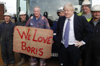 Britain's Prime Minister Boris Johnson poses with workers during a visit to Wilton Engineering Services, part of a General Election campaign trail stop in Middlesbrough, England, Wednesday, Nov. 20, 2019. Britain goes to the polls on Dec. 12. (AP Photo/Frank Augstein, Pool)
