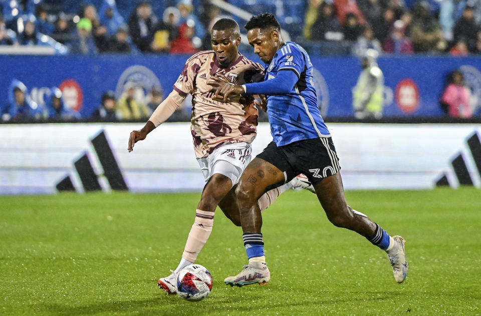 CF Montreal's Romell Quioto, right, holds off a challenge from Portland Timbers' Juan Mosquera during the first half of an MLS soccer game in Montreal, Saturday, Oct. 7, 2023. (Graham Hughes/The Canadian Press via AP)