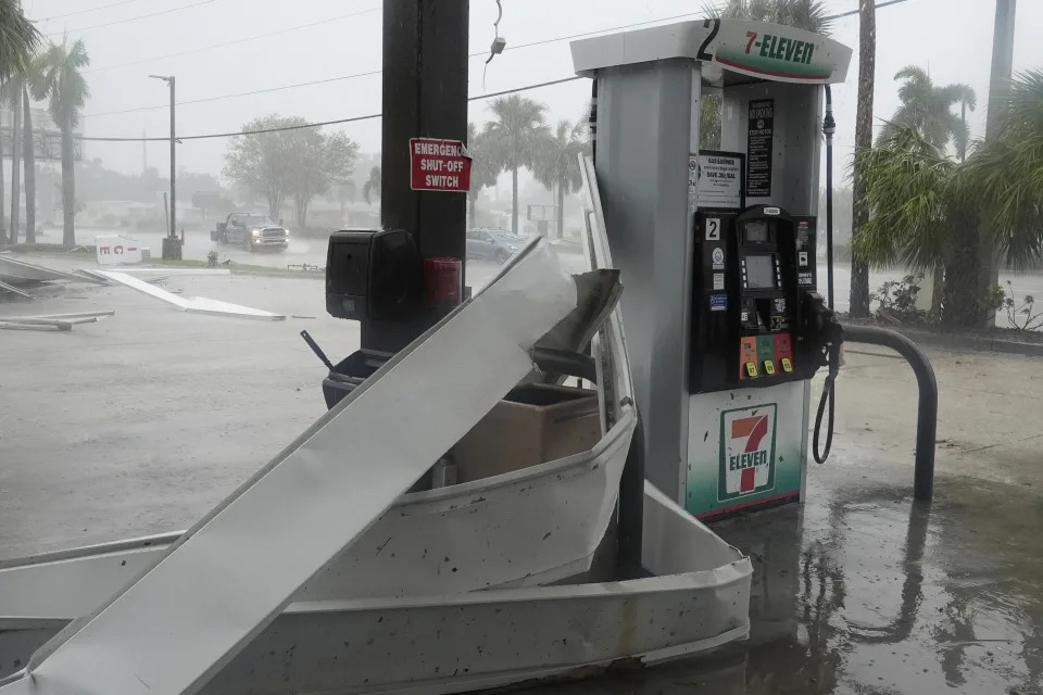 An apparent tornado caused by Hurricane Milton, tore the awning off a 7-Eleven convenient store, Wednesday, Oct. 9, 2024, in Cape Coral, Fla.(AP Photo/Marta Lavandier)