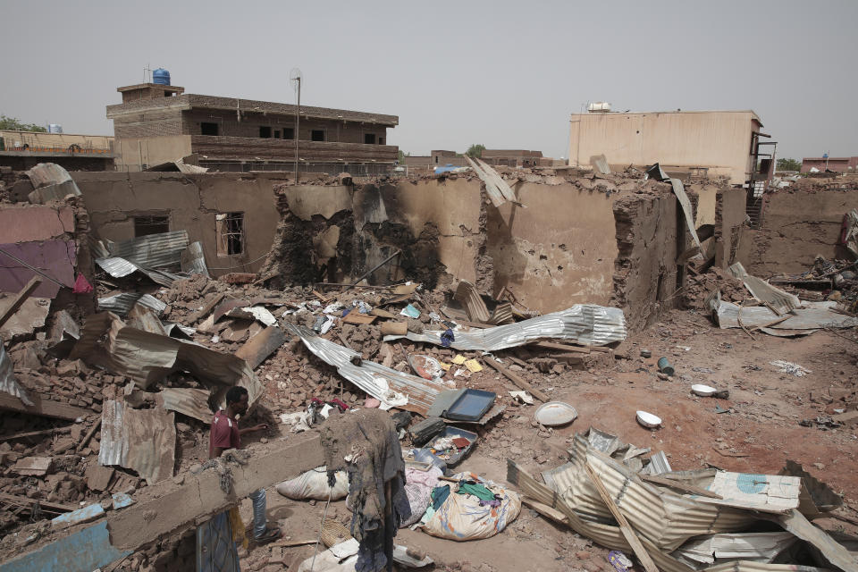 FILE - A man walks by a house hit in recent fighting in Khartoum, Sudan, April 25, 2023. The U.S. conducted its first organized evacuation of citizens and permanent residents from Sudan, the State Department said Saturday, April 29, two weeks into a conflict that has turned Khartoum into a war zone and thrown the country into turmoil. American unmanned aircraft, which have been keeping an eye on overland evacuation routes for days, were providing armed overwatch for the American operation, according to two people briefed on the operation who were not authorized to speak publicly. (AP Photo/Marwan Ali, File)