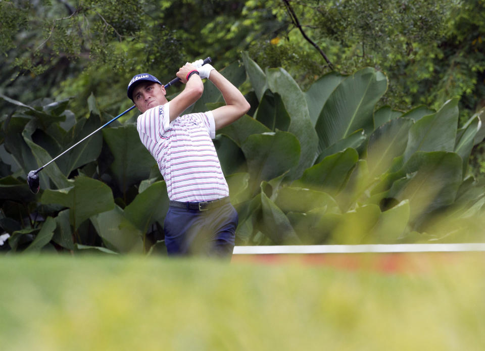 Justin Thomas of the United States follows his shot on the fifth hole during round two of the CIMB Classic golf tournament at Tournament Players Club (TPC) in Kuala Lumpur, Malaysia, Friday, Oct. 12, 2018. (AP Photo/Yam G-Jun)