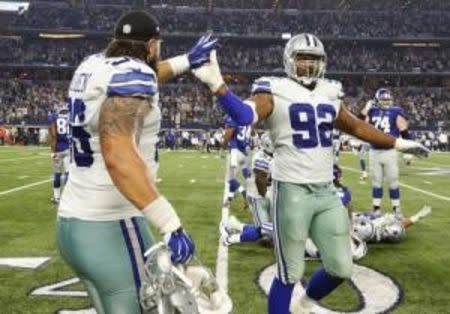 Sep 13, 2015; Arlington, TX, USA; Dallas Cowboys defensive end Jeremy Mincey (92) and defensive tackle Nick Hayden (96) celebrate a victory after the game against the New York Giants at AT&T Stadium. Mandatory Credit: Matthew Emmons-USA TODAY Sports