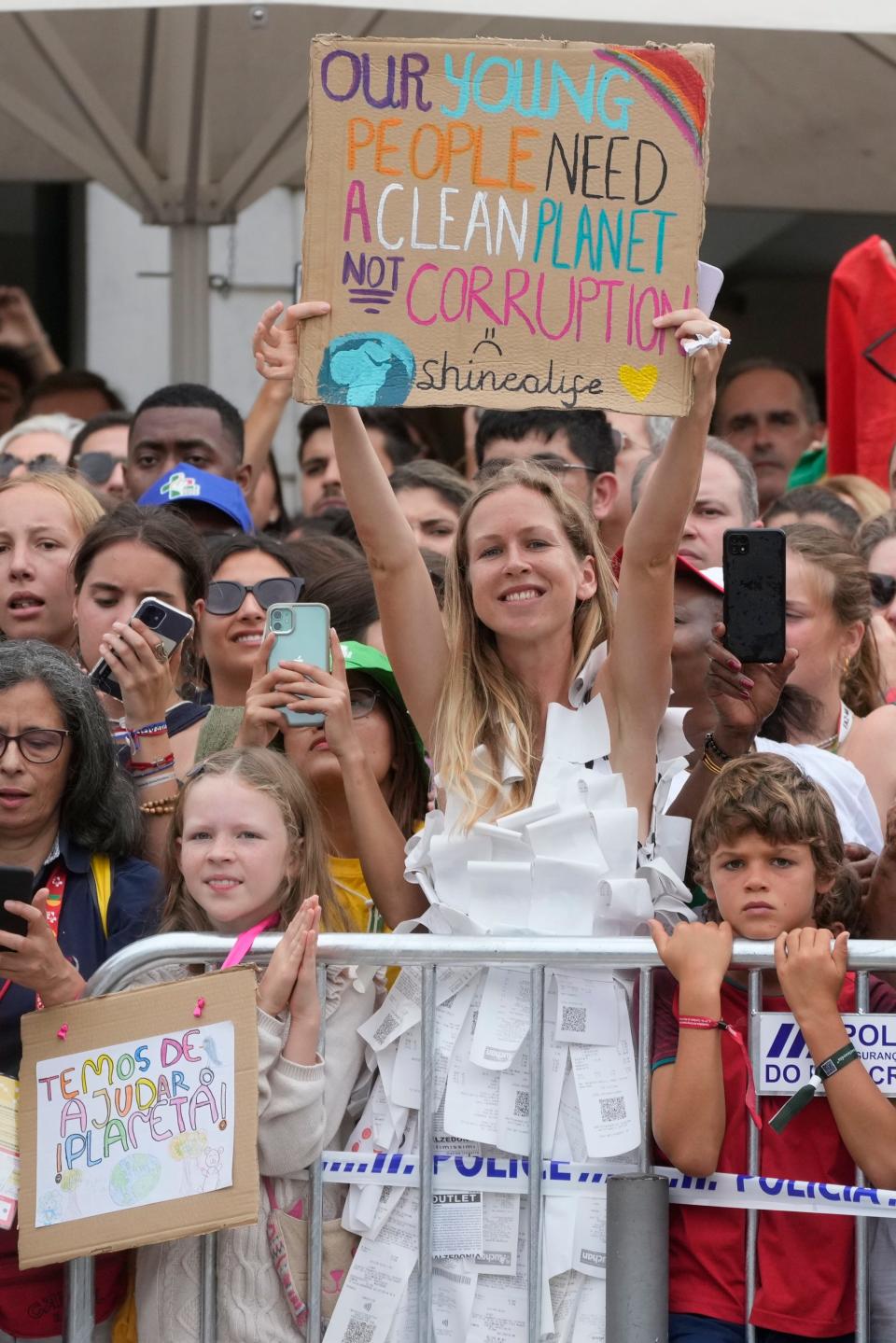 People wait outside the Palácio Nacional de Belém presidential palace in Lisbon, Wednesday, Aug. 2, 2023, where Pope Francis was attending a welcome ceremony. Pope Francis arrived Wednesday in Lisbon to attend the international World Youth Day on Sunday that is expected to bring hundreds of thousands of young Catholic faithful to Portugal.