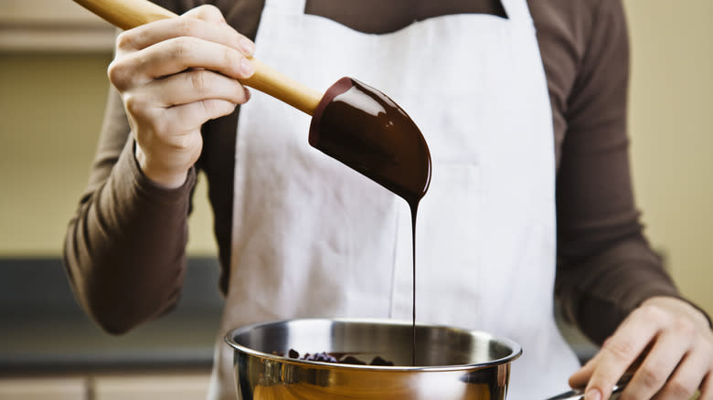 Person handling melted chocolate