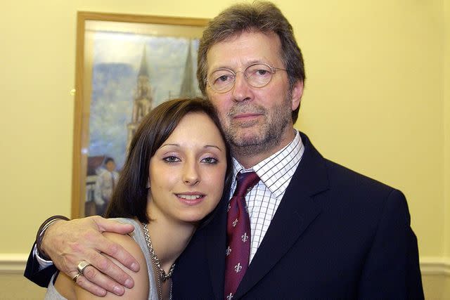 <p>Getty</p> Eric Clapton poses with his daughter Ruth before a performance in Birkdale school sports hall on March 18, 2003.