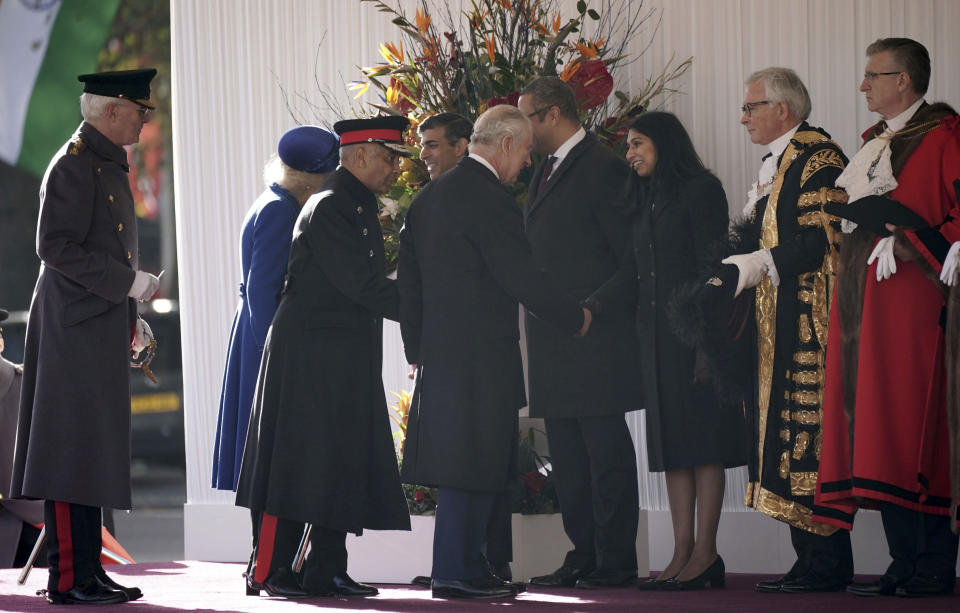 Britain's King Charles III shakes hands with Home Secretary Suella Braverman at Horse Guards Parade in London, Tuesday Nov. 22, 2022, ahead of the two day state visit of South Africa's President Cyril Ramaphosa. (Yui Mok/Pool via AP)