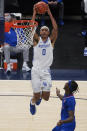 Kentucky's Jacob Toppin (0) goes to the basket against Kansas' Marcus Garrett (0) during the second half of an NCAA college basketball game Tuesday, Dec. 1, 2020, in Indianapolis. (AP Photo/Darron Cummings)