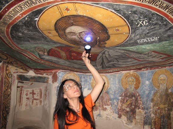 The researchers analyzed some of the paintings on site using various techniques, including infrared, ultraviolet and X-ray fluorescence imaging. Here, UCLA archaeologist Ioanna Kakoulli examines a painting in the monastery under UV light.