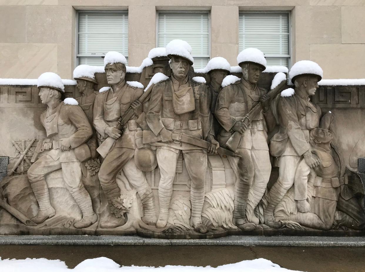 Snow tops the helmets of soldiers on the World War I Memorial in downtown Jackson, MS. An atypical heavy snow fell in the southern city overnight. Friday, December 8, 2017.