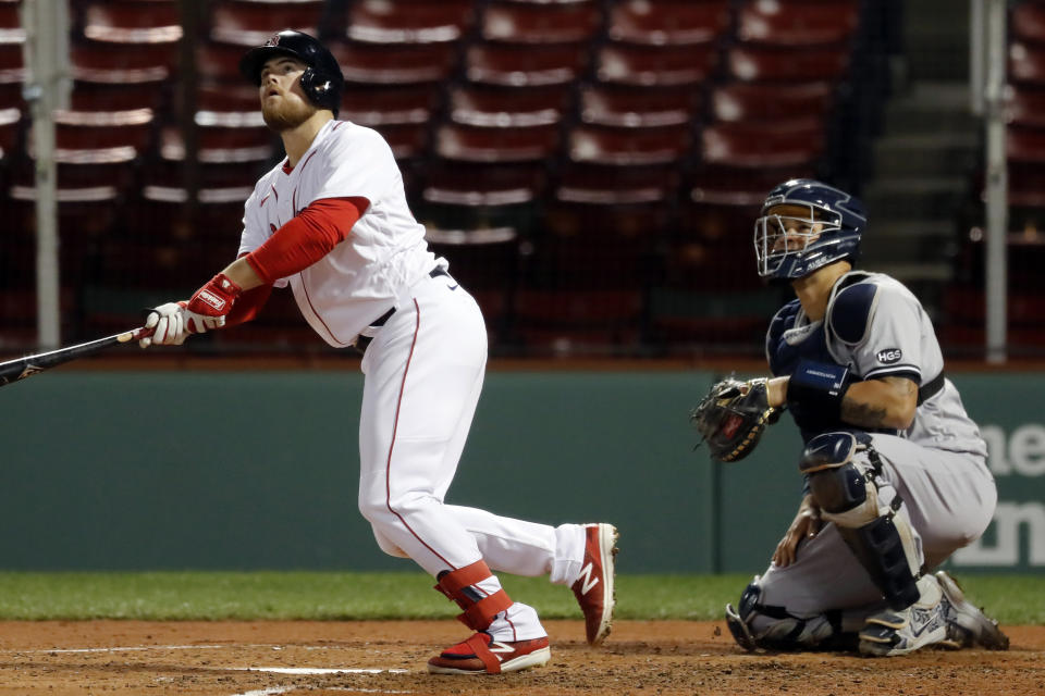 Boston Red Sox's Christian Arroyo watches his three-run home run in front of New York Yankees catcher Gary Sanchez during the fourth inning of a baseball game Friday, Sept. 18, 2020, in Boston. (AP Photo/Michael Dwyer)