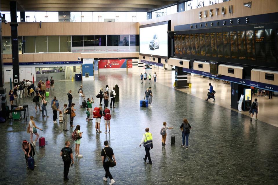 People look at departure information screens at Euston railway station during the August rail strikes (REUTERS)