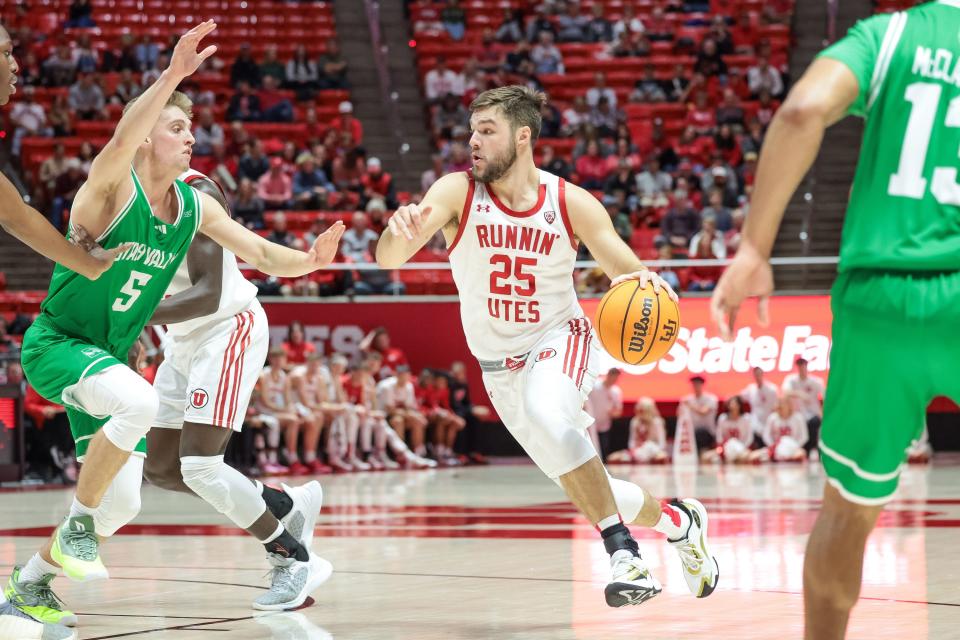 Utah Utes guard Rollie Worster (25) drives during the game against the Utah Valley Wolverines at the Huntsman Center in Salt Lake City on Saturday, Dec. 16, 2023. | Spenser Heaps, Deseret News
