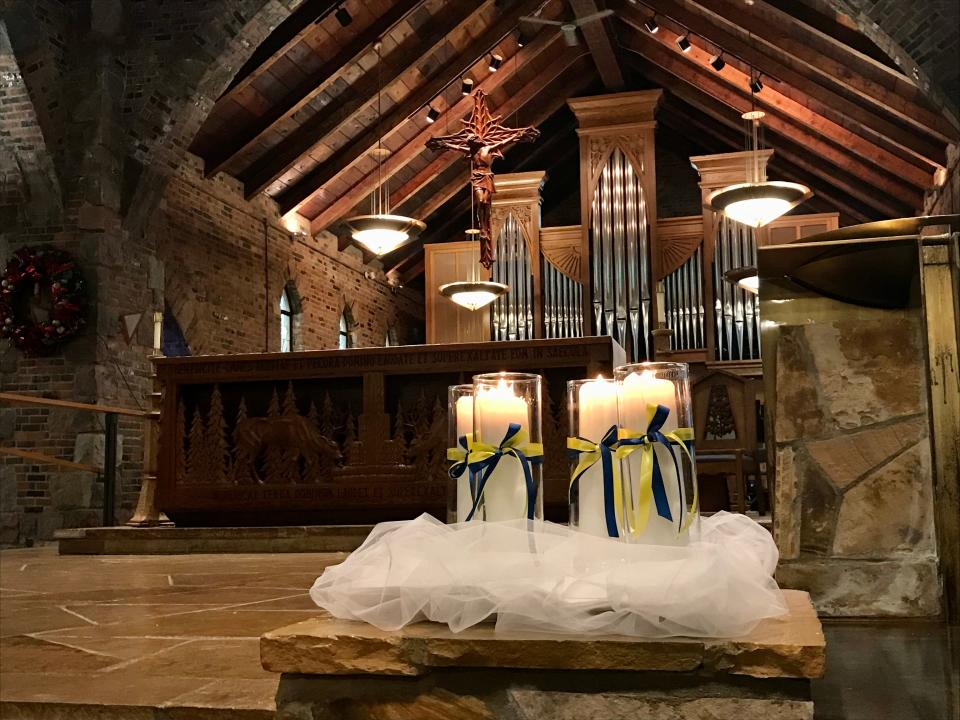 Four candles are lit at St. Joseph Catholic Church in Orion Township on Dec. 5, 2021, to honor four Oxford High School students who died after a shooting.