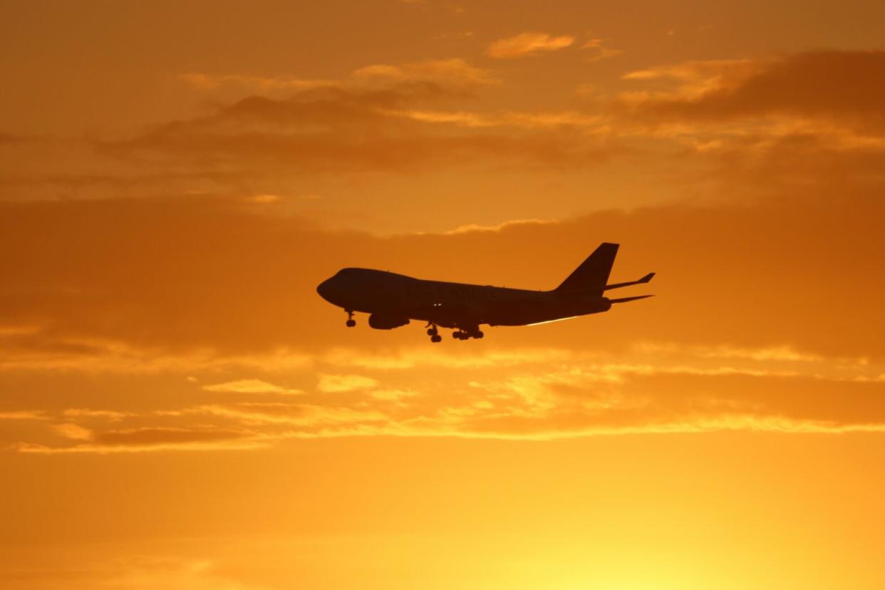 plane flying during sunset