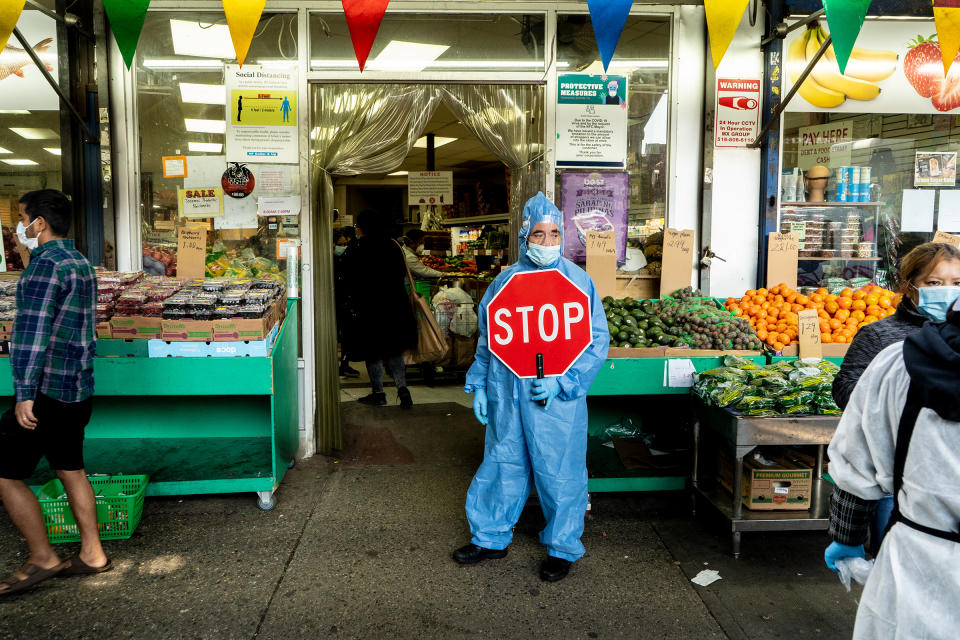 A man guards the entrance to H. F. Dollar and Up grocery store in Queens, April 25<span class="copyright">Camilo José Vergara</span>