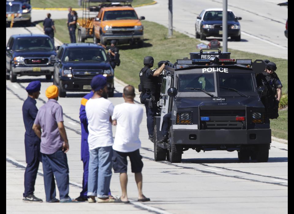A gunman shoots six people dead during Sunday services at a Sikh temple in Oak Creek, Wisconsin, before he is shot dead by a police officer.<br>  <em>Caption: People watch police personnel outside the Sikh Temple in Oak Creek, Wis., where a shooting took place Sunday, Aug 5, 2012. (AP Photo/Jeffrey Phelps)</em>