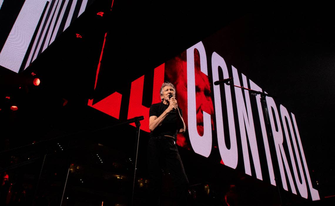 Roger Waters performs in concert at Raleigh, N.C.’s PNC Arena, Thursday night, Aug. 18, 2022 as messages scroll on video screens above his head.