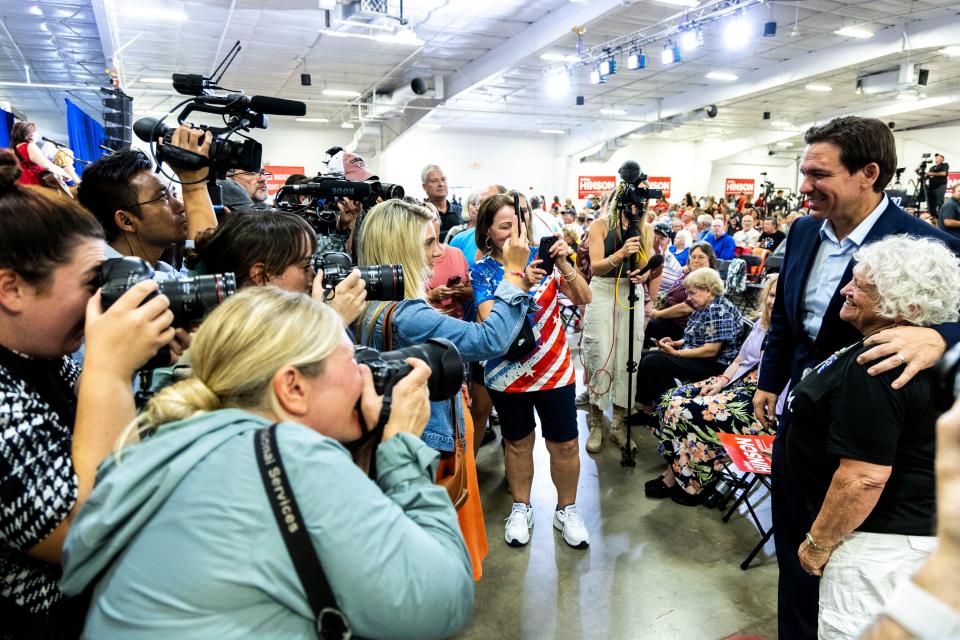 Republican presidential candidate Florida Gov. Ron DeSantis poses for photos with supporters as journalists document the scene during the Ashley's BBQ Bash fundraiser, Sunday, Aug. 6, 2023, at Hawkeye Downs in Cedar Rapids, Iowa.