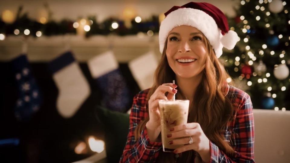 Lindsay Lohan in a Santa hat and Christmas pajamas drinks Pepsi mixed with Milk in a commercial