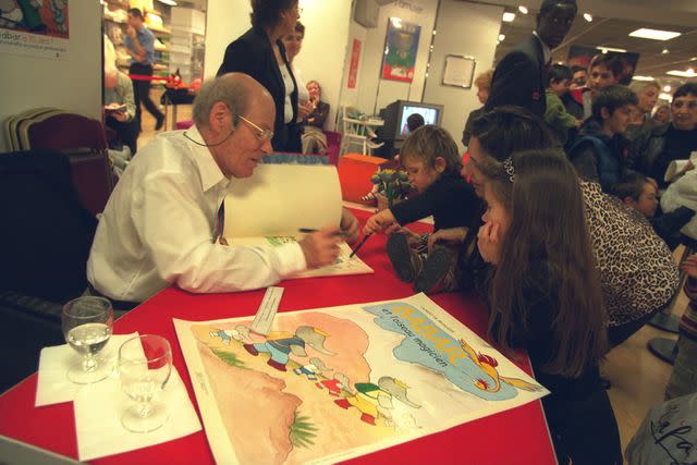 <p>Yves Forestier/Sygma via Getty</p> De Brunhoff signing authographs for Babar's 70th birthday