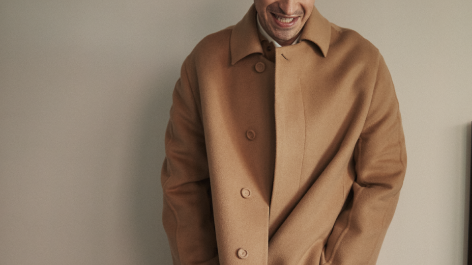 a man wearing a brown coat