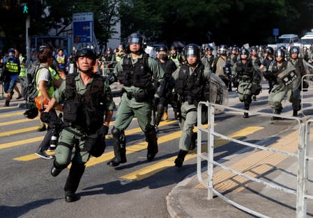 Riot police advance during an anti-government march in Tuen Mun, Hong Kong