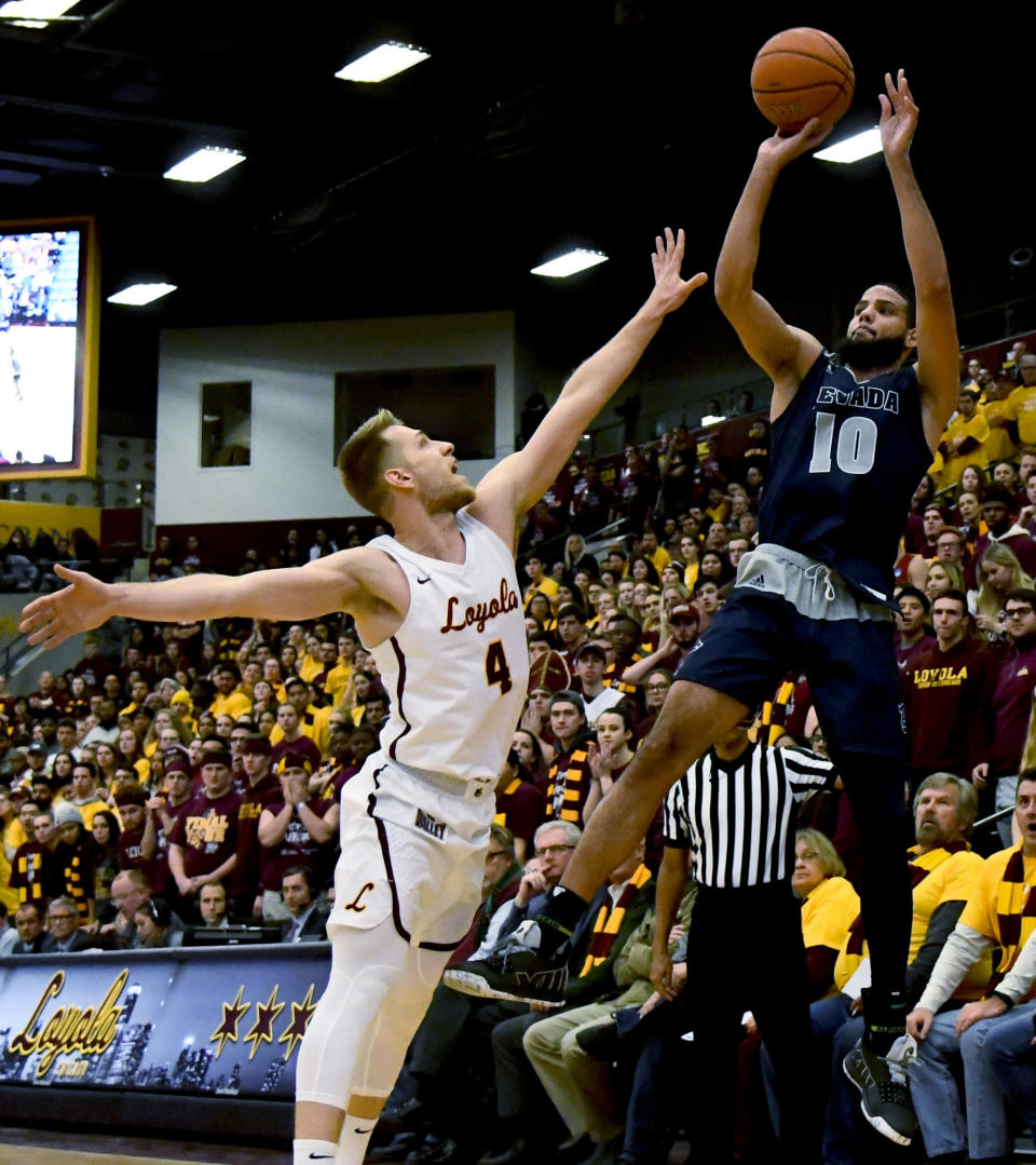 Nevada forward Caleb Martin (10) shoots over Loyola of Chicago guard Bruno Skokna (4) during the first half of an NCAA college basketball game in Chicago, Tuesday, Nov. 27, 2018. (AP Photo/Matt Marton)