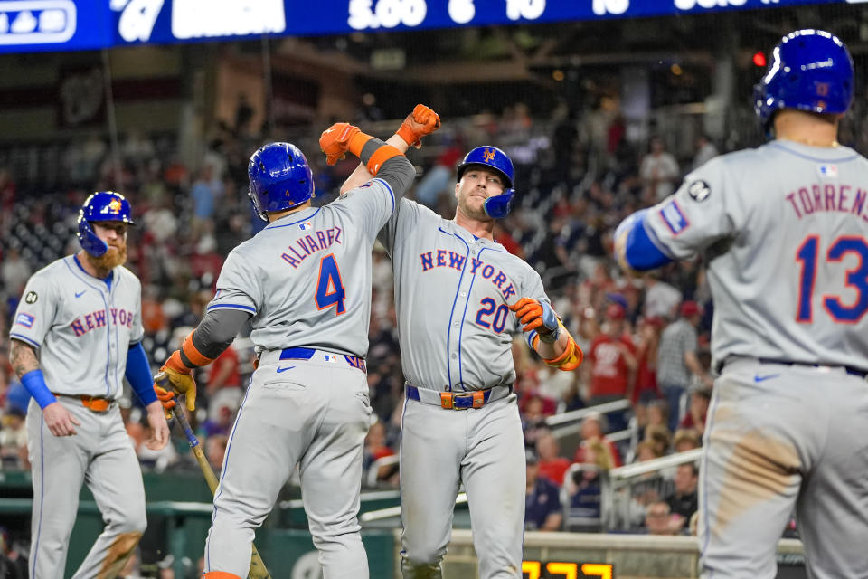New York Mets' Pete Alonso, second from right, celebrates his two-run homer with Francisco Alvarez, with Ben Gamel, left, and Luis Torrens, right, during the 10th inning of a baseball game against the Washington Nationals at Nationals Park, Tuesday, July 2, 2024, in Washington. The Mets won 7-2 in 10 innings. (AP Photo/Alex Brandon)