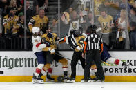 Florida Panthers defenseman Marc Staal (18) pulls back Vegas Golden Knights defenseman Nicolas Hague, left, from Florida Panthers defenseman Marc Staal, held back by referee, during the third period of Game 1 of the NHL hockey Stanley Cup Finals, Saturday, June 3, 2023, in Las Vegas. The Golden Knights defeated the Panthers 5-2. (AP Photo/John Locher)