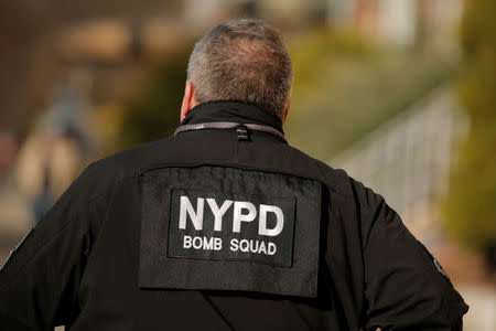 A New York City Police Department (NYPD) Bomb Squad officer walks outside a home in the Brooklyn borough of New York City while they investigate an earlier incident at the New York Port Authority Bus Terminal in Manhattan where there was an explosion, New York, U.S. December 11, 2017. REUTERS/Lucas Jackson