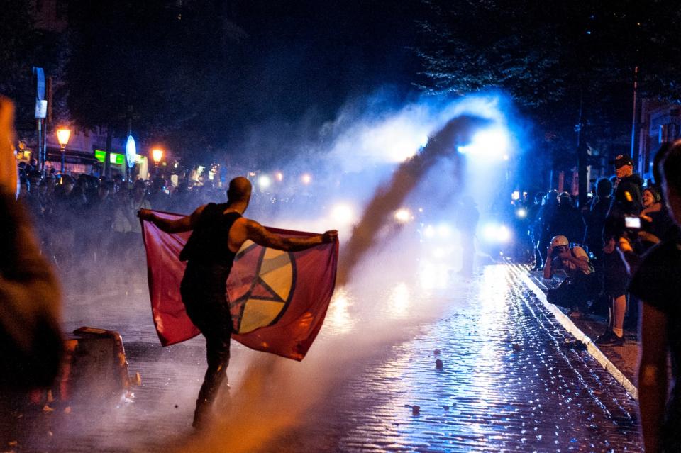 <p>A demonstrator is hit by a water gun, in Hamburg, Germany, on July 6, 2017. (Photo: Markus Heine/NurPhoto via Getty Images) </p>