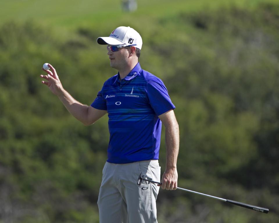 Zach Johnson waves to the gallery after winning the Tournament of Champions golf tournament, Monday, Jan. 6, 2014, in Kapalua, Hawaii. Johnson pulled away with three straight birdies on the back nine at Kapalua and closed with a 7-under 66 for a one-shot victory over Jordan Spieth on Monday. (AP Photo/Marco Garcia)