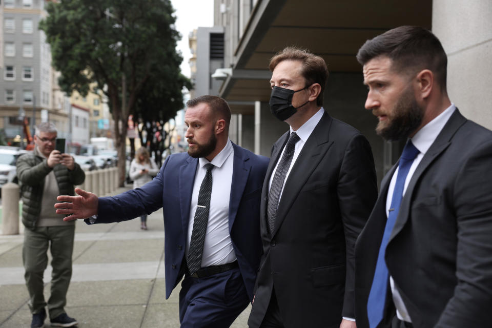 SAN FRANCISCO, CALIFORNIA - FEBRUARY 03: Tesla CEO Elon Musk (C) leaves the Phillip Burton Federal Building on February 03, 2023 in San Francisco, California. Closing arguments have wrapped up in the trial where investors are suing Tesla and Elon Musk, its chief executive officer, over his August 2018 tweets where he said he was taking Tesla private with funding that he secured. The tweet was found to be false and cost shareholders billions of dollars when Tesla's stock price began to fluctuate wildly allegedly based on the tweet. (Photo by Justin Sullivan/Getty Images)