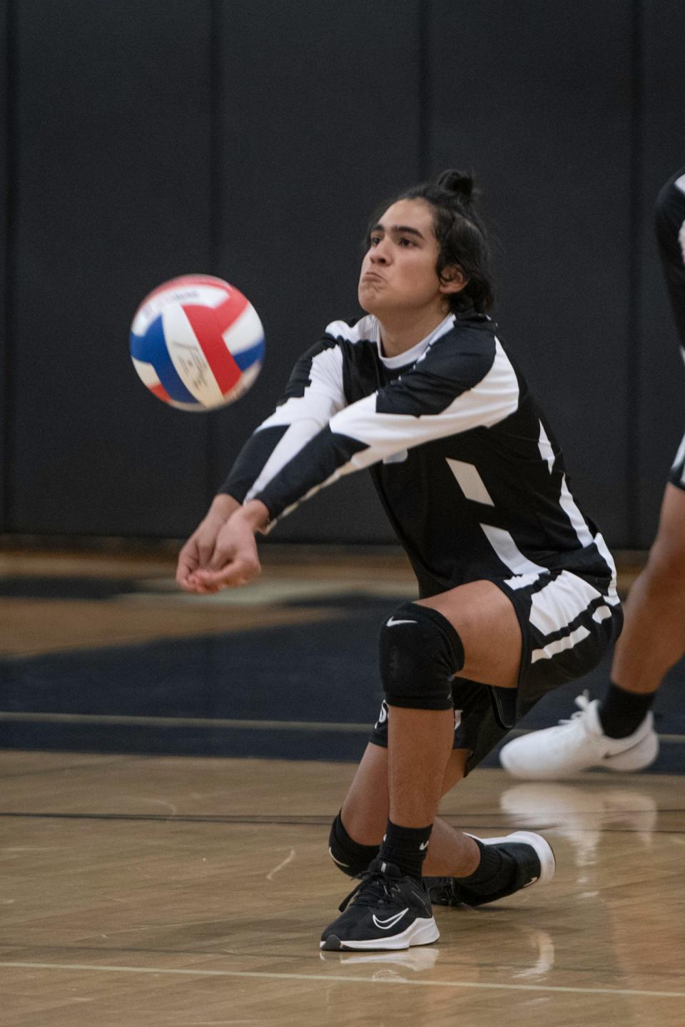 Pueblo South's Luke Vasquez goes down for a dig during a matchup with Colorado Springs Christian on March 30, 2022.